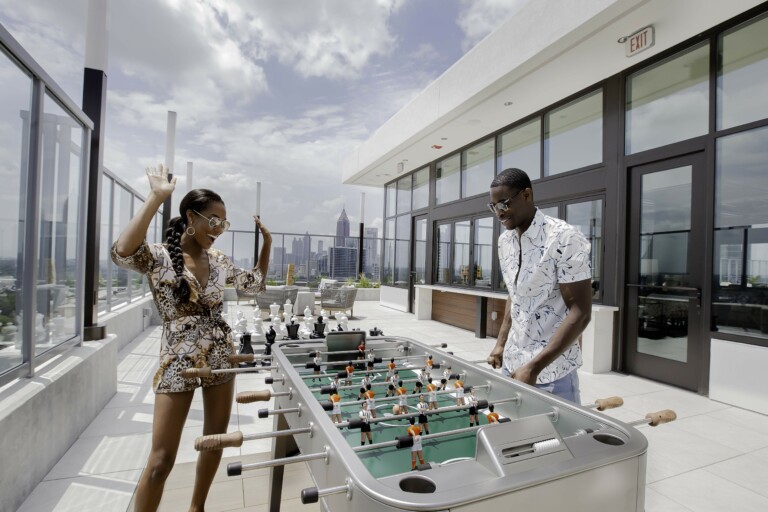 Vireo man and woman playing foosball on rooftop